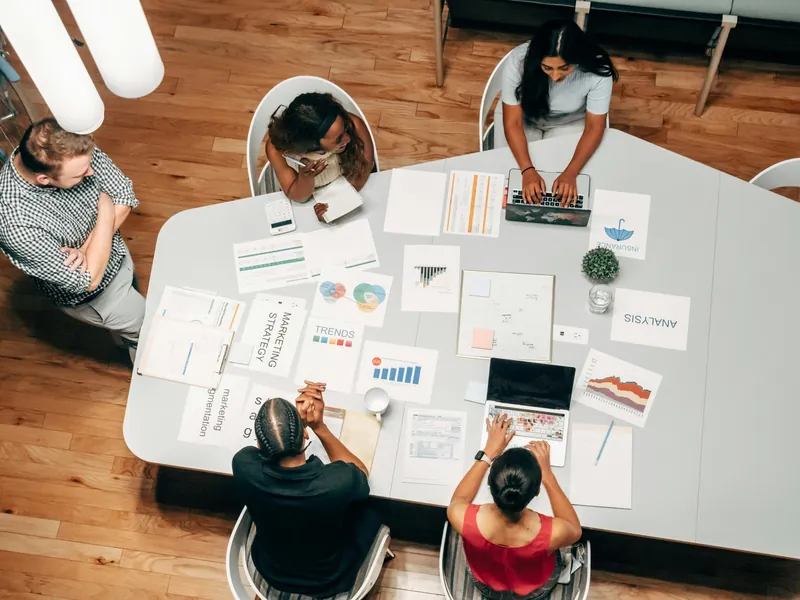 A team working through strategy documents around a table