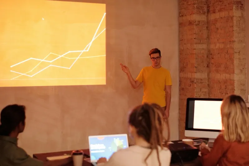 A team reviewing a rising performance chart